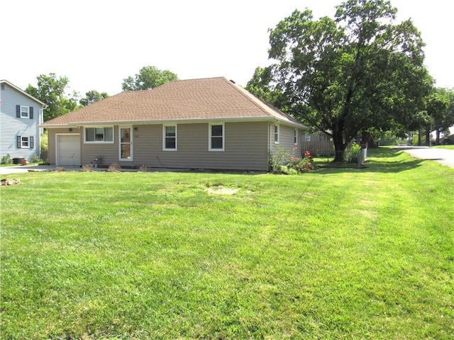 502 N Jefferson St, Spring Hill, KS 66083 - rear view of property with a garage, a yard, and driveway