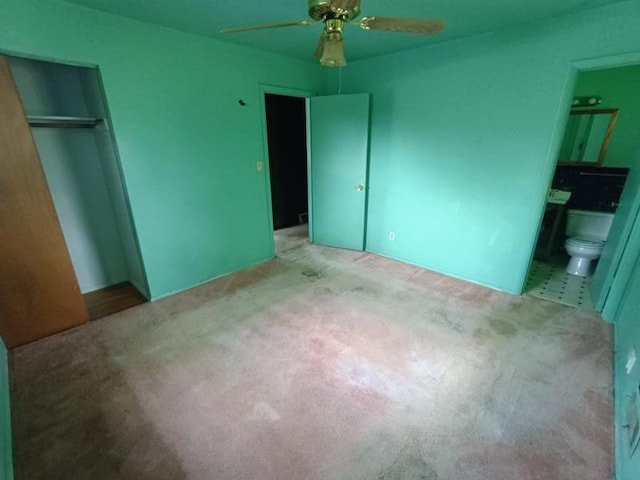 5001 E 41st St, Kansas City, MO 64130 - unfurnished bedroom with a closet, ensuite bath, carpet floors, and ceiling fan
