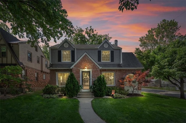 1295 W 71st Ter, Kansas City, MO 64114 - traditional home with brick siding, a front yard, and a chimney