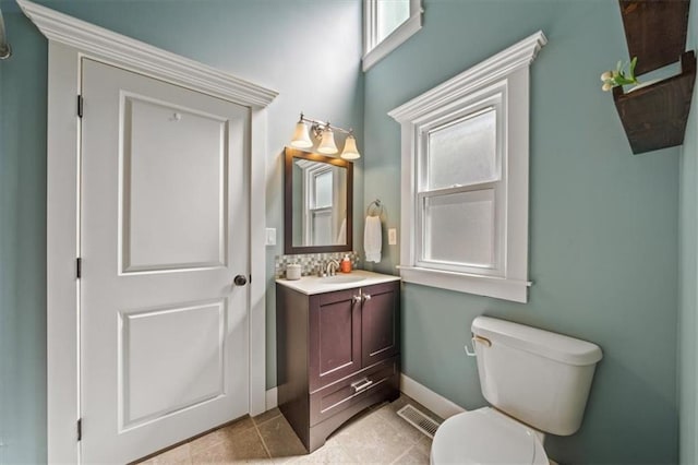 1295 W 71st Ter, Kansas City, MO 64114 - bathroom with plenty of natural light, vanity, and tile patterned flooring