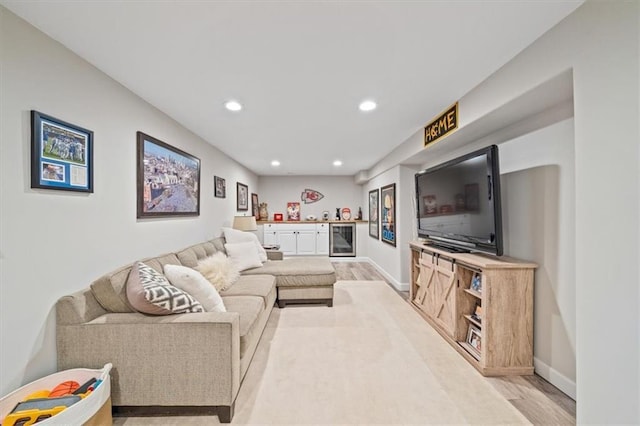 1295 W 71st Ter, Kansas City, MO 64114 - living area featuring beverage cooler, recessed lighting, light wood finished floors, and a dry bar