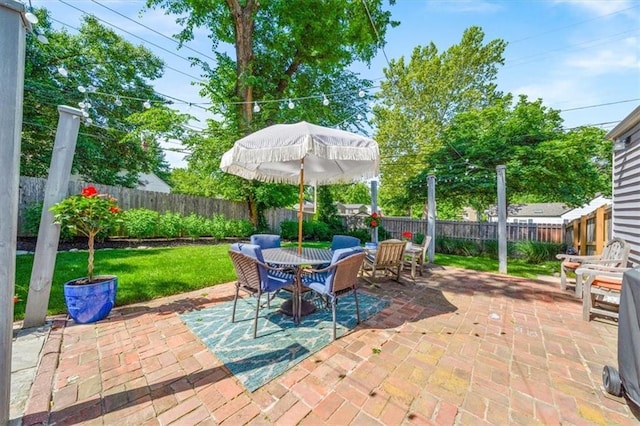 1295 W 71st Ter, Kansas City, MO 64114 - fenced backyard featuring outdoor dining space and a patio area