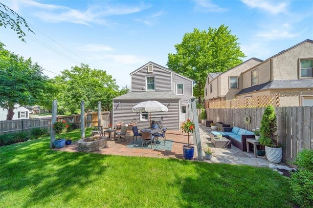 1295 W 71st Ter, Kansas City, MO 64114 - back of house featuring an outdoor living space with a fire pit, a patio, and a fenced backyard