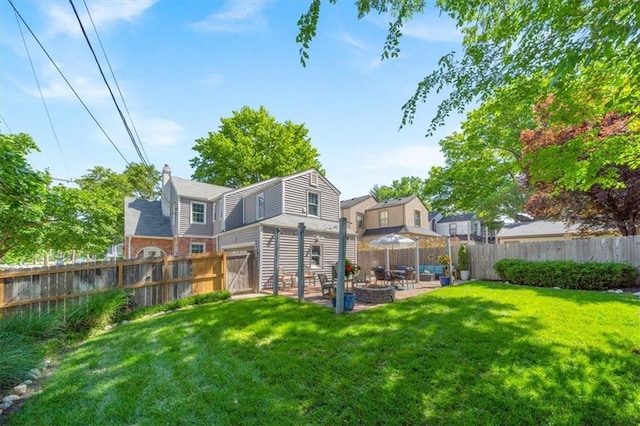 1295 W 71st Ter, Kansas City, MO 64114 - back of house with a fenced backyard, a patio area, a fire pit, and a chimney
