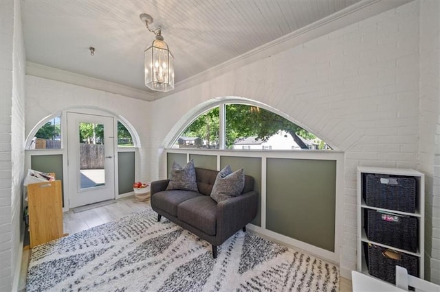 1295 W 71st Ter, Kansas City, MO 64114 - sitting room featuring ornamental molding, a chandelier, and wood finished floors