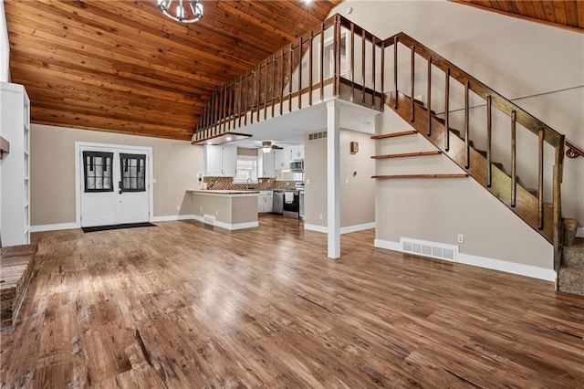 6727 Harvard Ave, Raytown, MO 64133 - unfurnished living room featuring wooden ceiling, high vaulted ceiling, wood finished floors, stairs, and ceiling fan