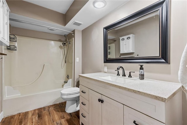 6727 Harvard Ave, Raytown, MO 64133 - bathroom featuring vanity, wood finished floors, and tub / shower combination