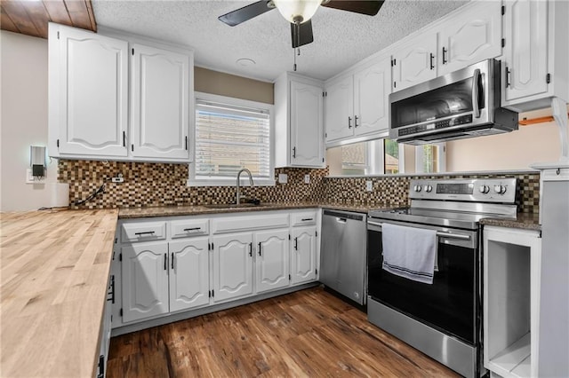 6727 Harvard Ave, Raytown, MO 64133 - kitchen featuring appliances with stainless steel finishes, white cabinets, ceiling fan, dark wood-type flooring, and a textured ceiling