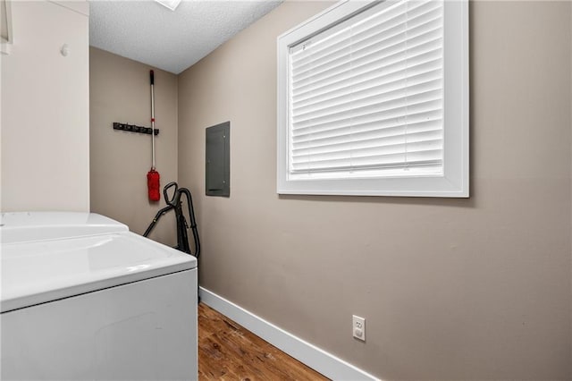 6727 Harvard Ave, Raytown, MO 64133 - laundry area featuring washing machine and dryer, electric panel, wood finished floors, and a textured ceiling