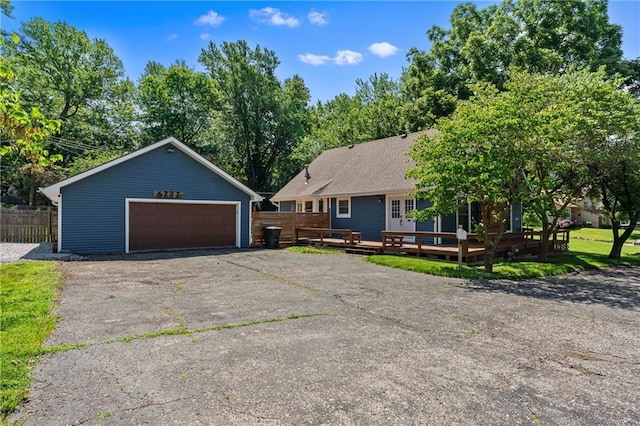 6727 Harvard Ave, Raytown, MO 64133 - ranch-style house with a garage, a wooden deck, and an outbuilding
