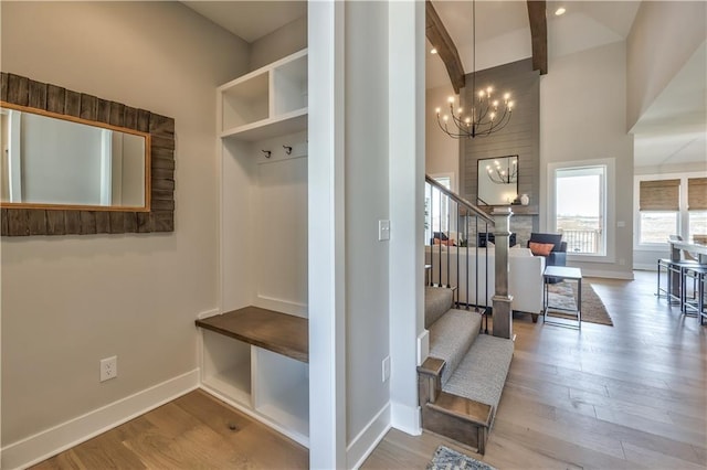3705 W 187th St, Overland Park, KS 66085 - mudroom featuring a chandelier, wood finished floors, and beamed ceiling