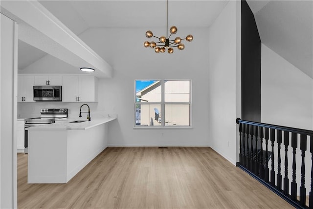 220 NE Dreamweaver Ave, Lees Summit, MO 64086 - kitchen with stainless steel microwave, lofted ceiling, light wood finished floors, electric range, and a chandelier