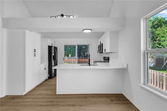 220 NE Dreamweaver Ave, Lees Summit, MO 64086 - kitchen with stainless steel microwave, range with electric stovetop, light countertops, and plenty of natural light