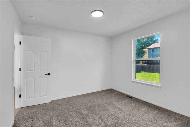 220 NE Dreamweaver Ave, Lees Summit, MO 64086 - carpeted spare room featuring a textured ceiling and a smoke detector