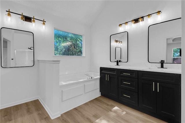 220 NE Dreamweaver Ave, Lees Summit, MO 64086 - bathroom with double vanity, a garden tub, wood finished floors, and lofted ceiling