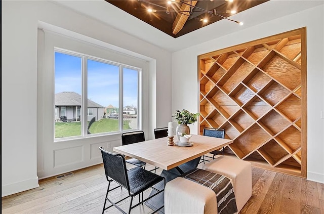 18501 Mohawk Ln, Overland Park, KS 66085 - dining area featuring light wood-type flooring and a chandelier