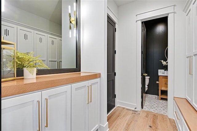18501 Mohawk Ln, Overland Park, KS 66085 - bathroom with wood finished floors and vanity
