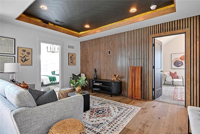 18501 Mohawk Ln, Overland Park, KS 66085 - living area featuring a raised ceiling and hardwood / wood-style floors
