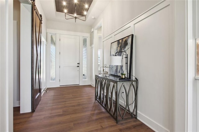 17162 S Heatherwood St, Olathe, KS 66062 - foyer with a barn door, dark wood-type flooring, and a chandelier