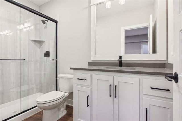 17162 S Heatherwood St, Olathe, KS 66062 - bathroom featuring vanity, a shower stall, and wood finished floors