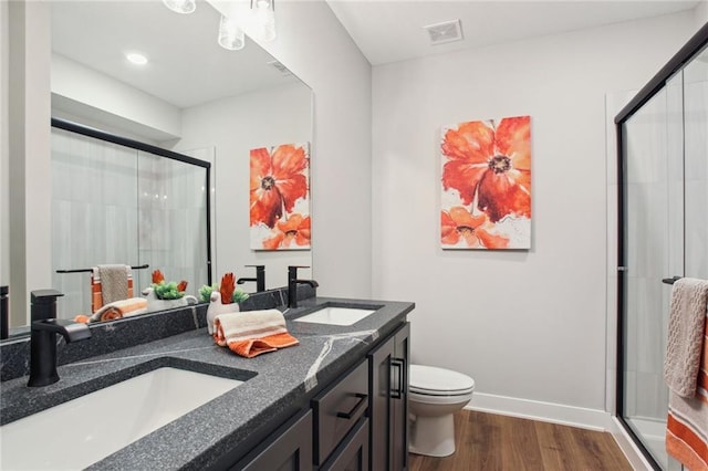 17162 S Heatherwood St, Olathe, KS 66062 - bathroom with wood finished floors, a stall shower, and double vanity