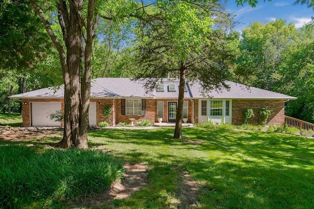 1100 Sycamore Ridge Dr, Lansing, KS 66043 - ranch-style house featuring a garage, brick siding, and a front yard