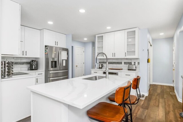 1100 Sycamore Ridge Dr, Lansing, KS 66043 - kitchen featuring stainless steel fridge, decorative backsplash, recessed lighting, glass insert cabinets, and dark wood-type flooring