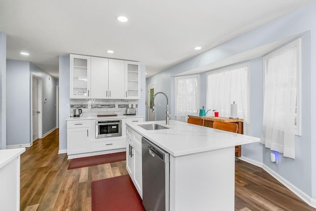 1100 Sycamore Ridge Dr, Lansing, KS 66043 - kitchen featuring stainless steel dishwasher, light countertops, dark wood-style floors, glass insert cabinets, and recessed lighting