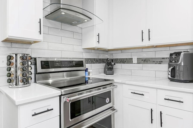 1100 Sycamore Ridge Dr, Lansing, KS 66043 - kitchen featuring range with two ovens, range hood, white cabinets, and light countertops