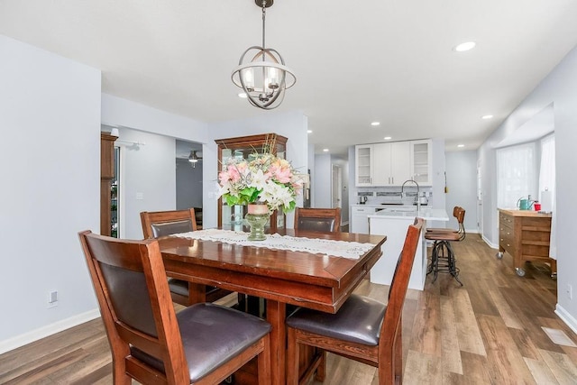 1100 Sycamore Ridge Dr, Lansing, KS 66043 - dining space with light wood-type flooring, a chandelier, and recessed lighting