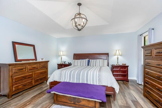 1100 Sycamore Ridge Dr, Lansing, KS 66043 - bedroom featuring a chandelier and wood finished floors
