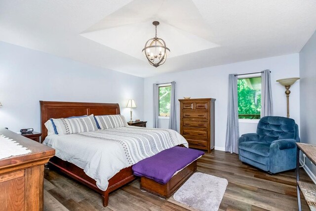 1100 Sycamore Ridge Dr, Lansing, KS 66043 - bedroom featuring a chandelier and wood finished floors