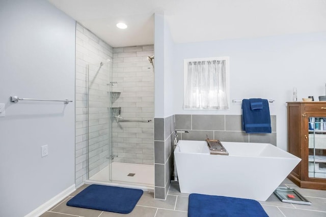 1100 Sycamore Ridge Dr, Lansing, KS 66043 - full bathroom featuring a freestanding bath, a stall shower, tile patterned flooring, and tile walls