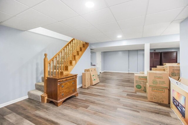 1100 Sycamore Ridge Dr, Lansing, KS 66043 - finished basement with stairs, wood finished floors, a drop ceiling, and recessed lighting