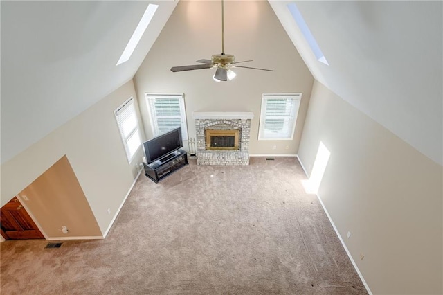 411 SW Windmill Ln, Lees Summit, MO 64082 - unfurnished living room featuring a skylight, plenty of natural light, high vaulted ceiling, and carpet flooring
