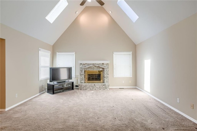 411 SW Windmill Ln, Lees Summit, MO 64082 - unfurnished living room with a skylight, high vaulted ceiling, a ceiling fan, and carpet