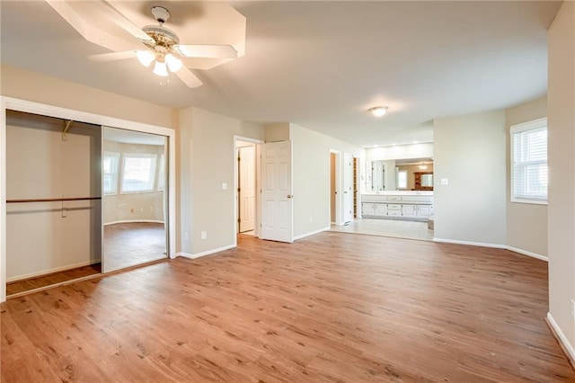 411 SW Windmill Ln, Lees Summit, MO 64082 - unfurnished living room with wood finished floors and a ceiling fan