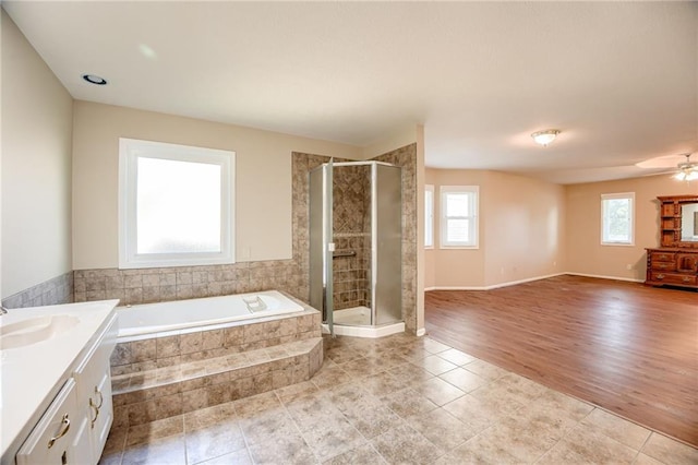 411 SW Windmill Ln, Lees Summit, MO 64082 - bathroom featuring healthy amount of natural light, a garden tub, vanity, and a stall shower