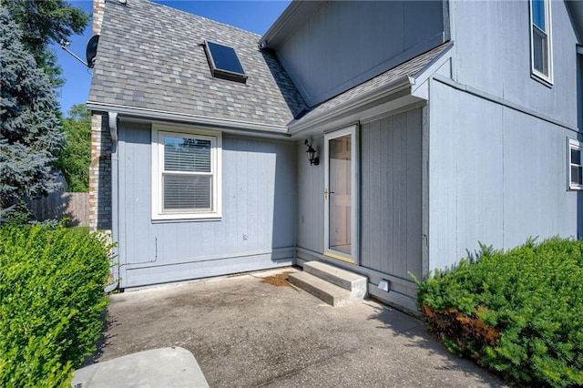 411 SW Windmill Ln, Lees Summit, MO 64082 - doorway to property with roof with shingles and a patio