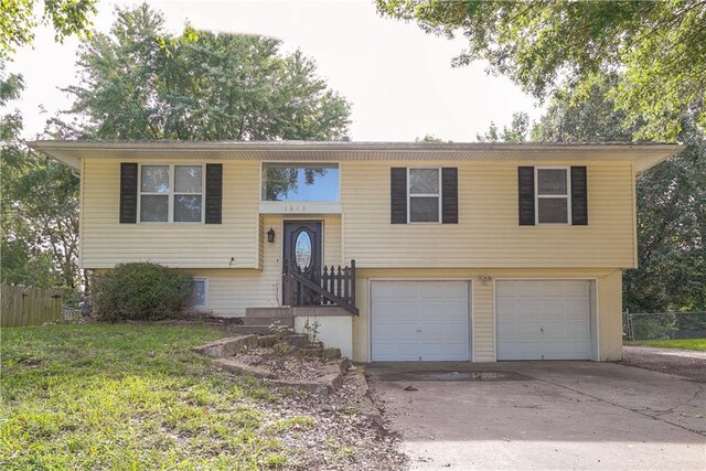 1613 SE Royal St, Oak Grove, MO 64075 - split foyer home with a garage and concrete driveway