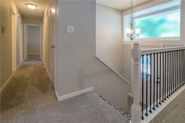 1613 SE Royal St, Oak Grove, MO 64075 - hall featuring an upstairs landing, carpet floors, a chandelier, and a textured ceiling