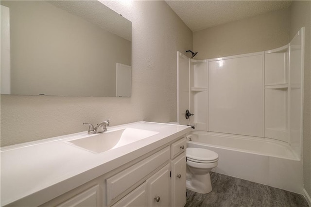 1613 SE Royal St, Oak Grove, MO 64075 - full bathroom with vanity, wood finished floors,  shower combination, and a textured ceiling