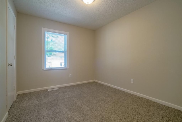 1613 SE Royal St, Oak Grove, MO 64075 - unfurnished room featuring carpet and a textured ceiling