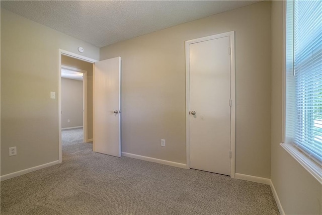 1613 SE Royal St, Oak Grove, MO 64075 - unfurnished bedroom with carpet flooring and a textured ceiling
