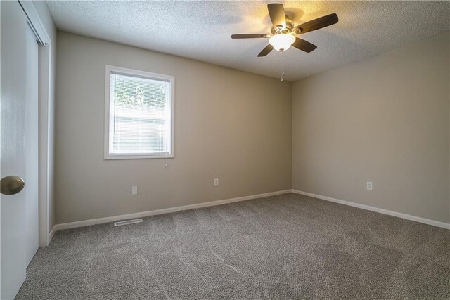1613 SE Royal St, Oak Grove, MO 64075 - carpeted empty room featuring ceiling fan and a textured ceiling