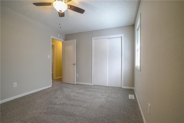 1613 SE Royal St, Oak Grove, MO 64075 - unfurnished bedroom featuring a textured ceiling, carpet, a closet, and ceiling fan