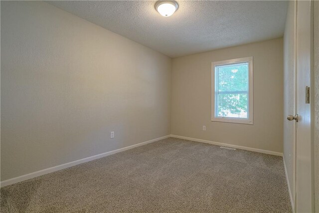 1613 SE Royal St, Oak Grove, MO 64075 - unfurnished room with a textured ceiling and carpet floors