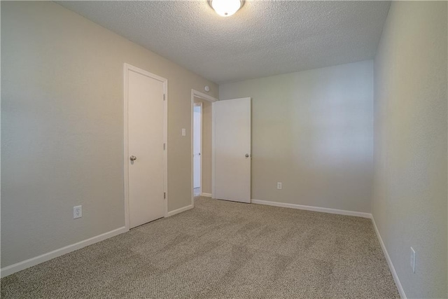 1613 SE Royal St, Oak Grove, MO 64075 - carpeted empty room featuring a textured ceiling and baseboards