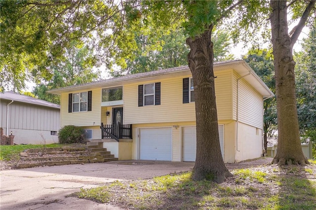 1613 SE Royal St, Oak Grove, MO 64075 - bi-level home with an attached garage and driveway