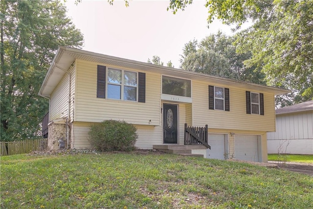 1613 SE Royal St, Oak Grove, MO 64075 - split foyer home with an attached garage and driveway